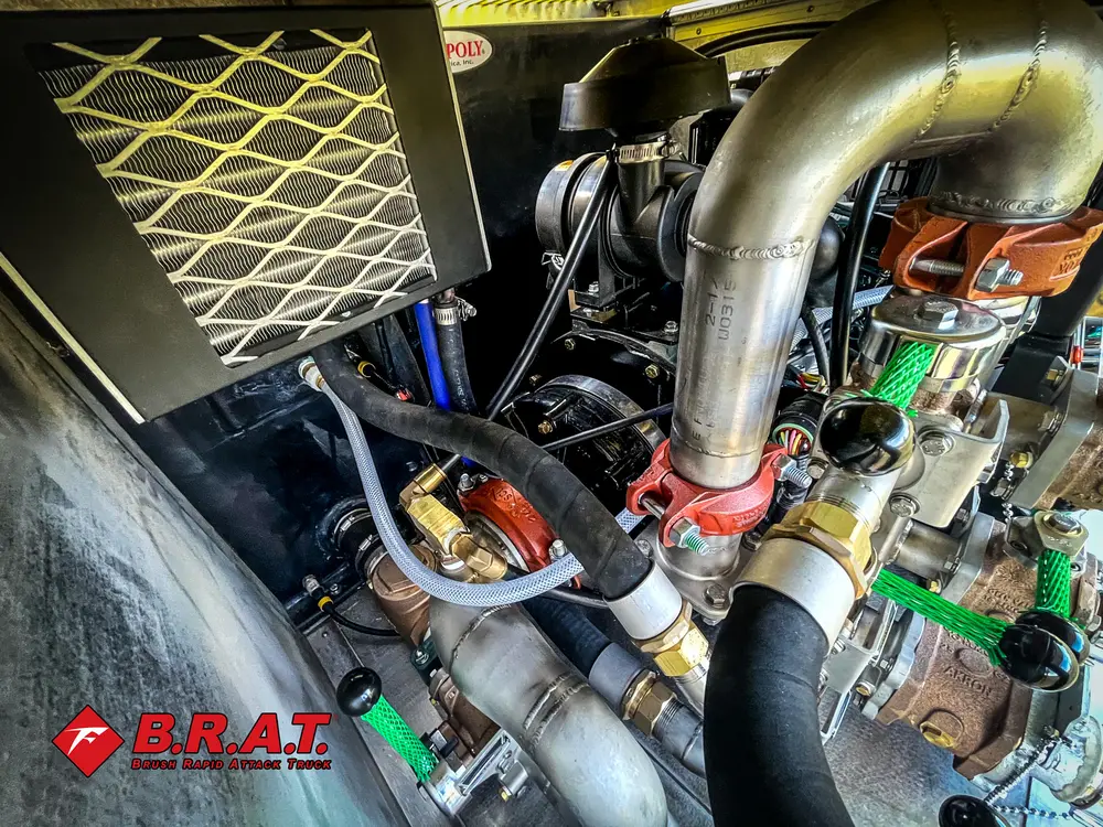 Exterior view of small fire truck showing cab, body compartments, and wheel/tire area.