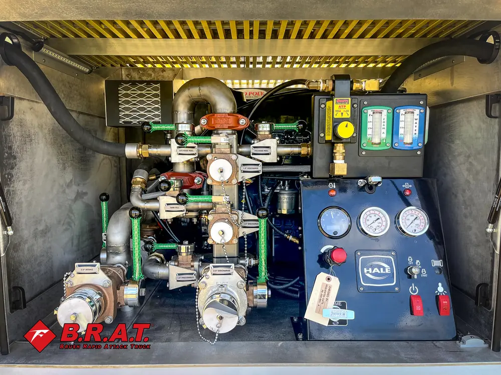 Exterior view of small fire truck showing cab, body compartments, and wheel/tire area.