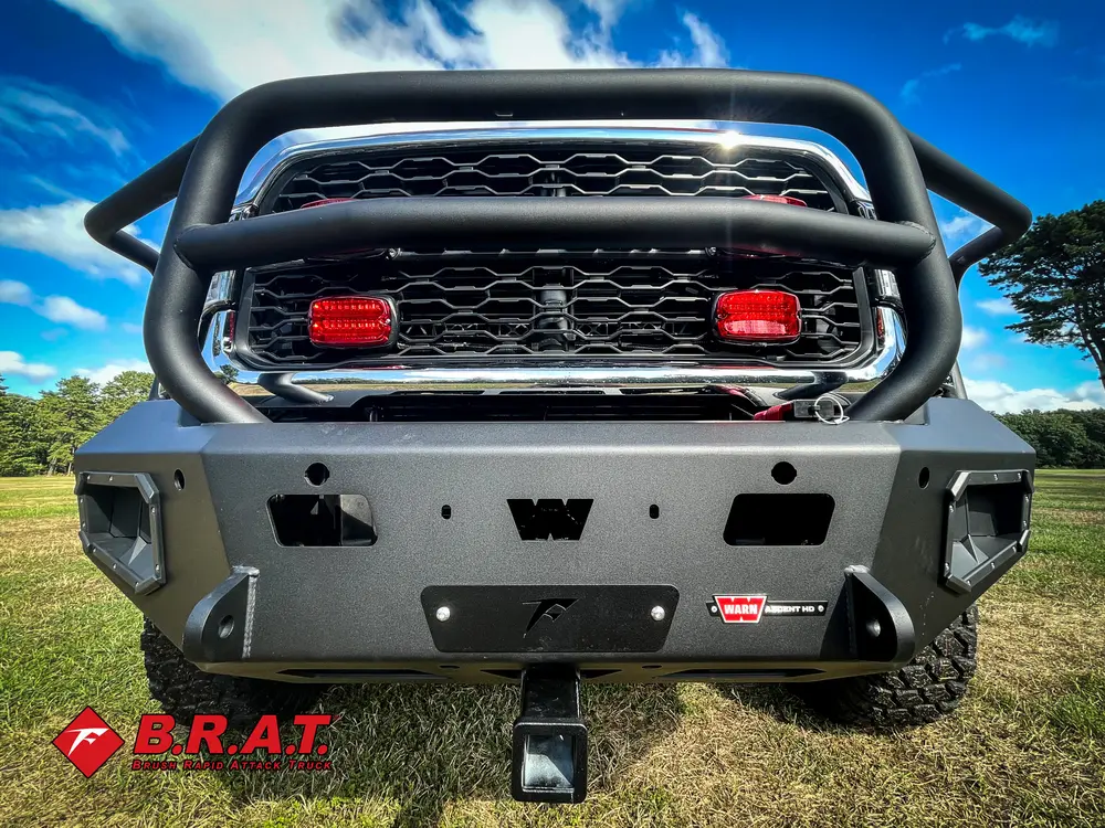 Exterior view of small fire truck showing cab, body compartments, and wheel/tire area.