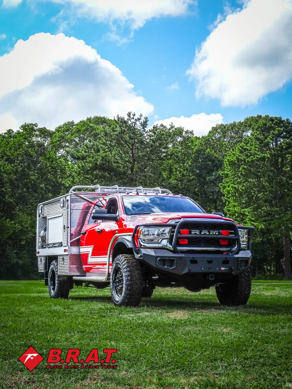 Exterior view of small fire truck showing cab, body compartments, and wheel/tire area.