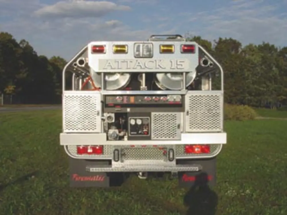 Exterior view of small fire truck showing cab, body compartments, and wheel/tire area.
