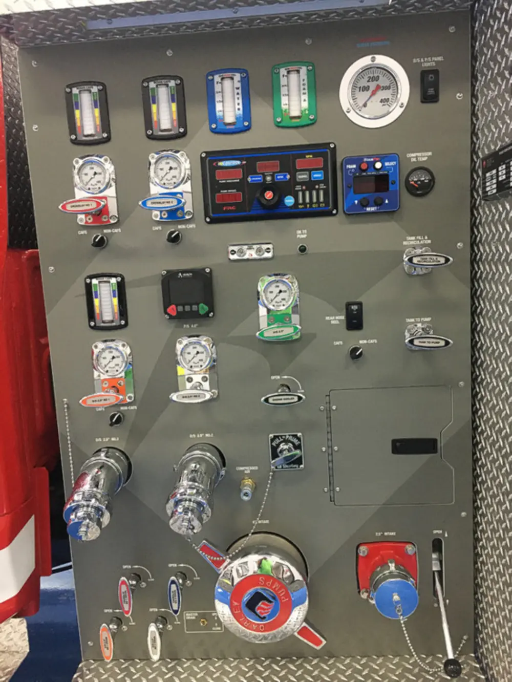 Exterior view of small fire truck showing cab, body compartments, and wheel/tire area.