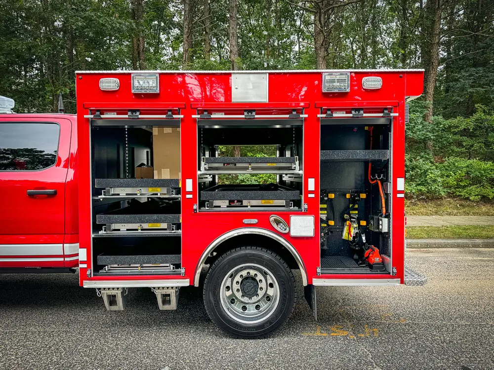 Right-side compartments open showing shelves and equipment bays.