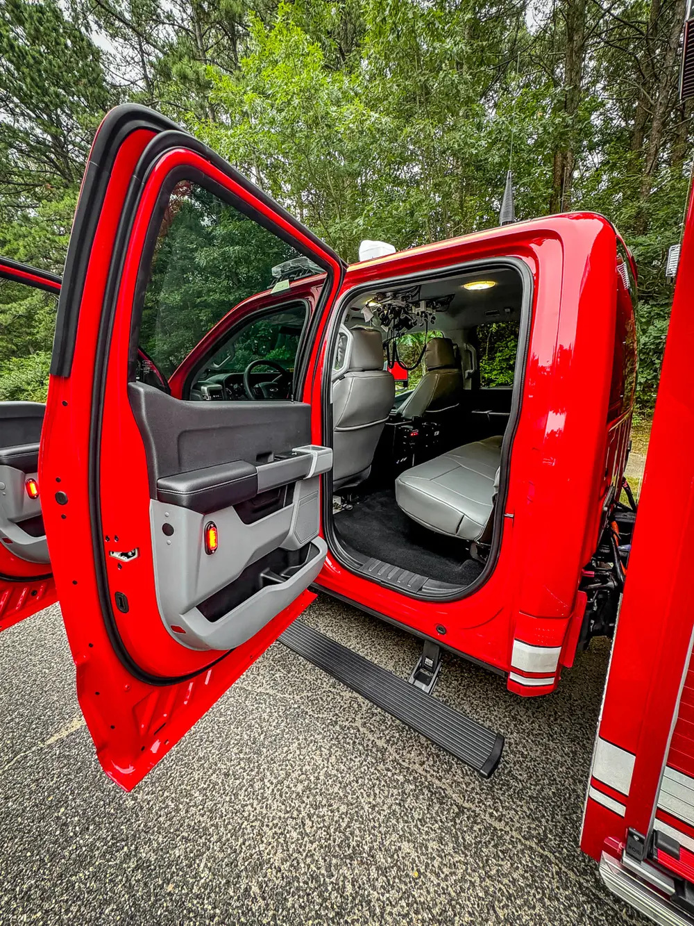 Open rear passenger door view showing rear seat area.