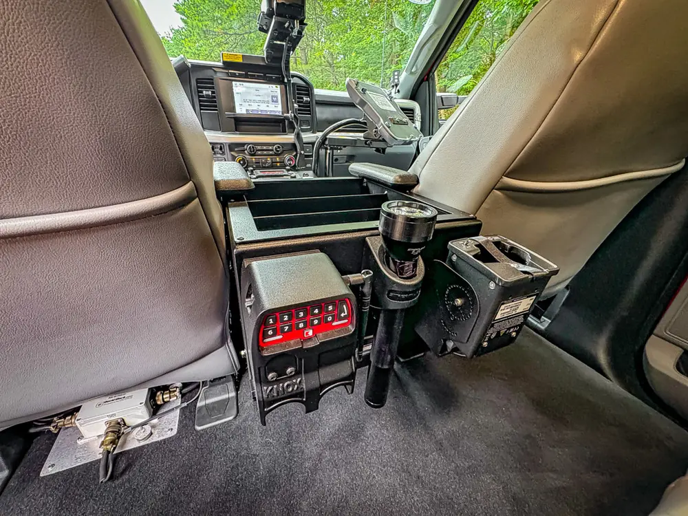 Rear floor area between front seats with mounted control equipment.