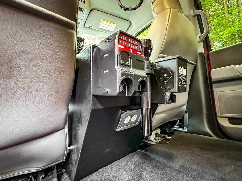 Rear center console and electronics mount behind front seats.