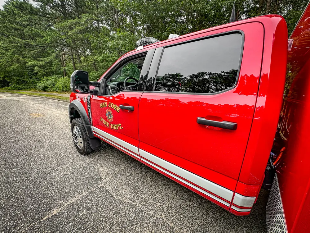 Left-side exterior profile of crew cab with body stripe and emblem.