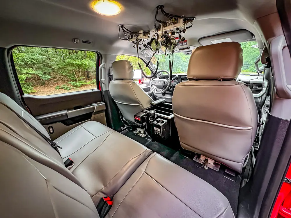 Rear cabin wide view showing front seats and overhead equipment.