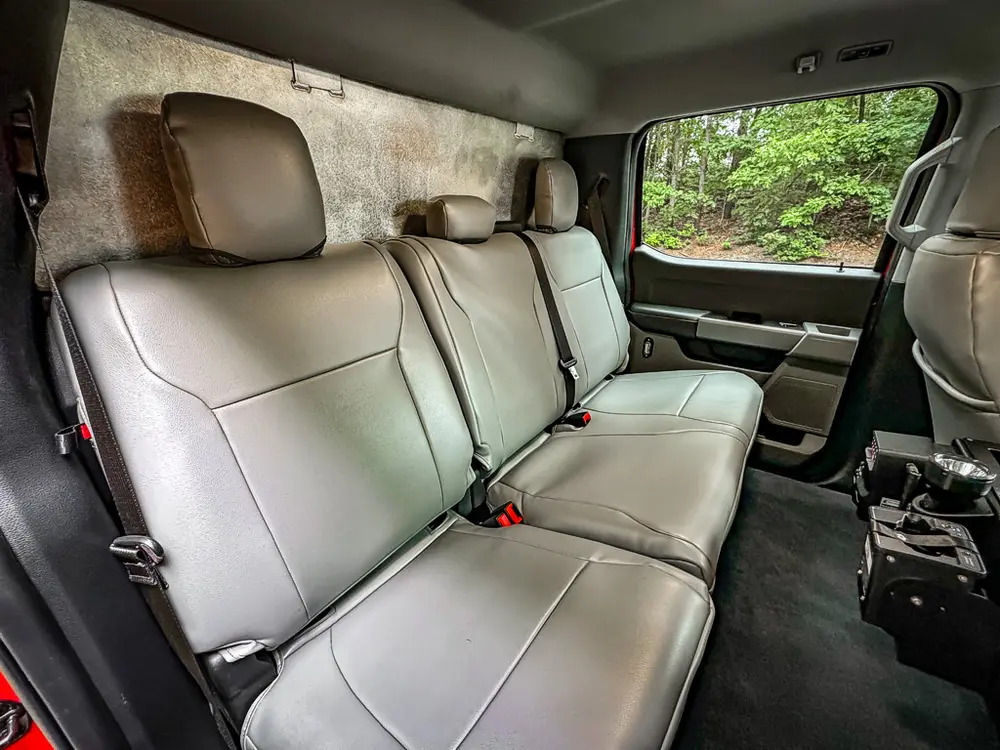Rear bench and floor area with mounted electronics near center tunnel.