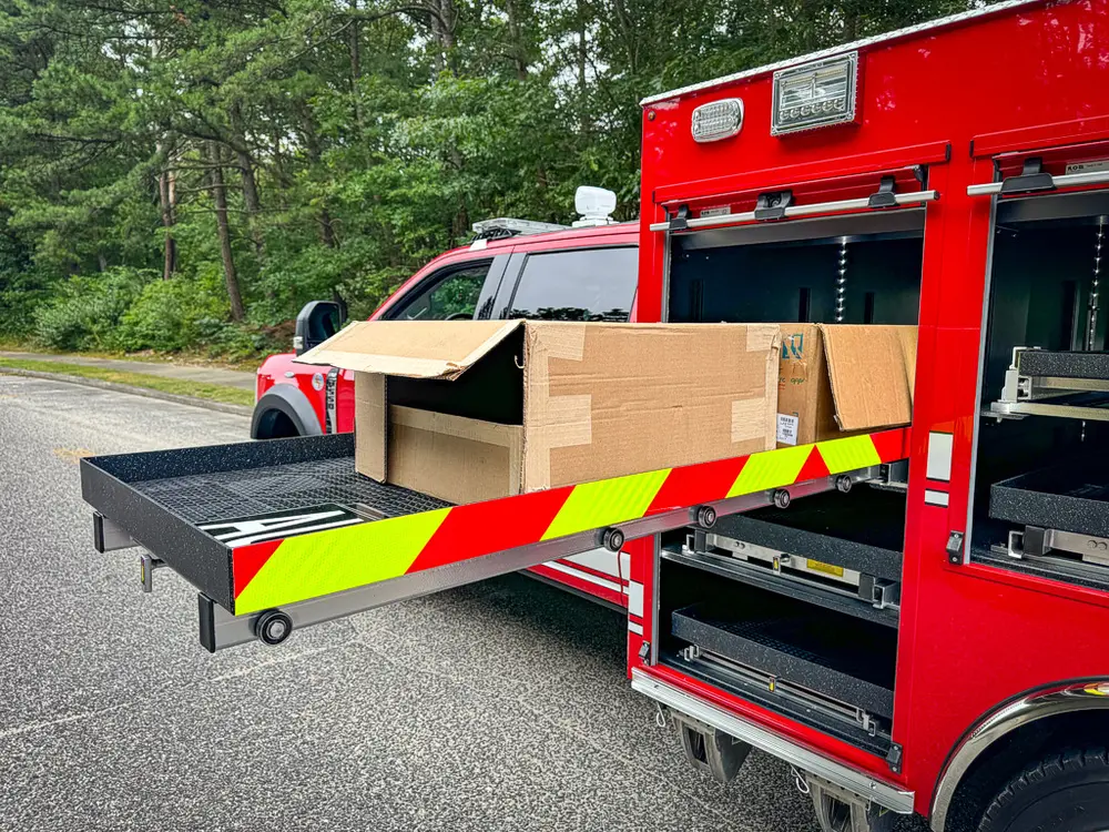 Side compartment view with extended tray and chevron-striped edge.