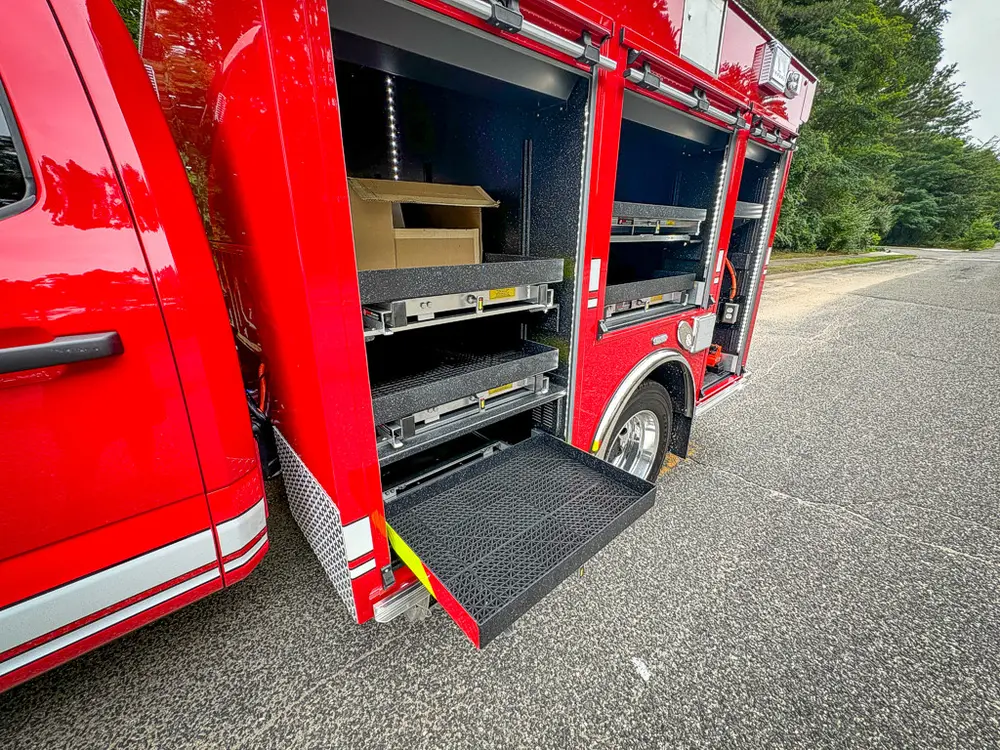 Angled side view of open compartments and nested slide-out trays.