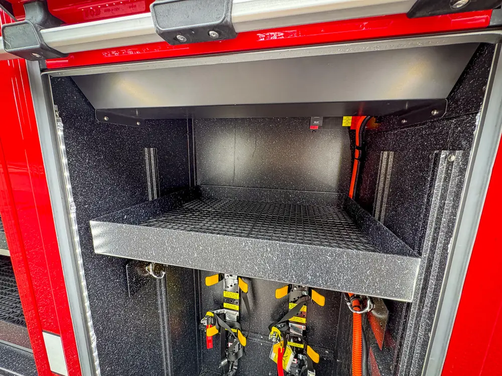 Deep side compartment interior with shelf and black anti-slip floor.