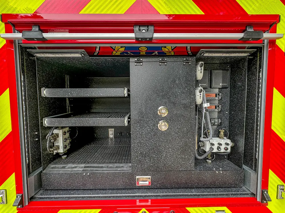 Rear compartment interior with shelves and side control modules.