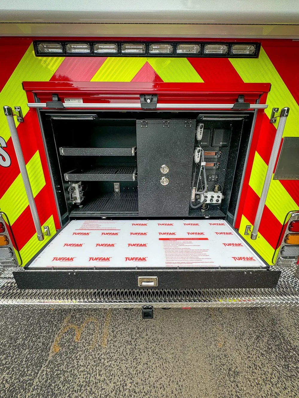 Rear compartment with floor panel open and white board inserted.