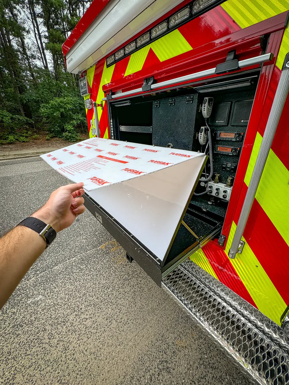 Rear fold-down panel close-up with white board section partially raised.