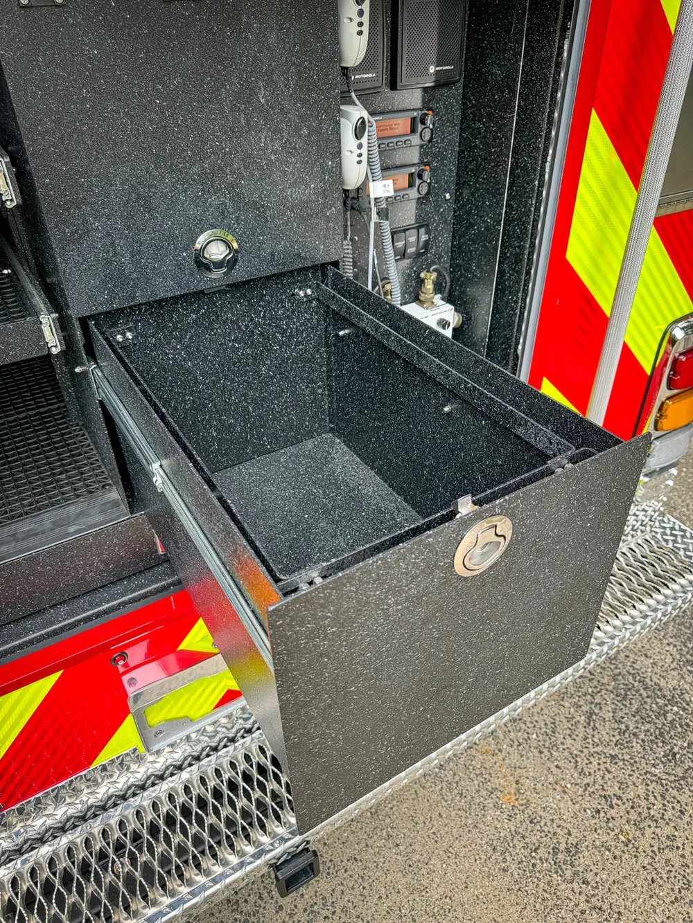 Rear compartment with black slide-out storage bin extended.