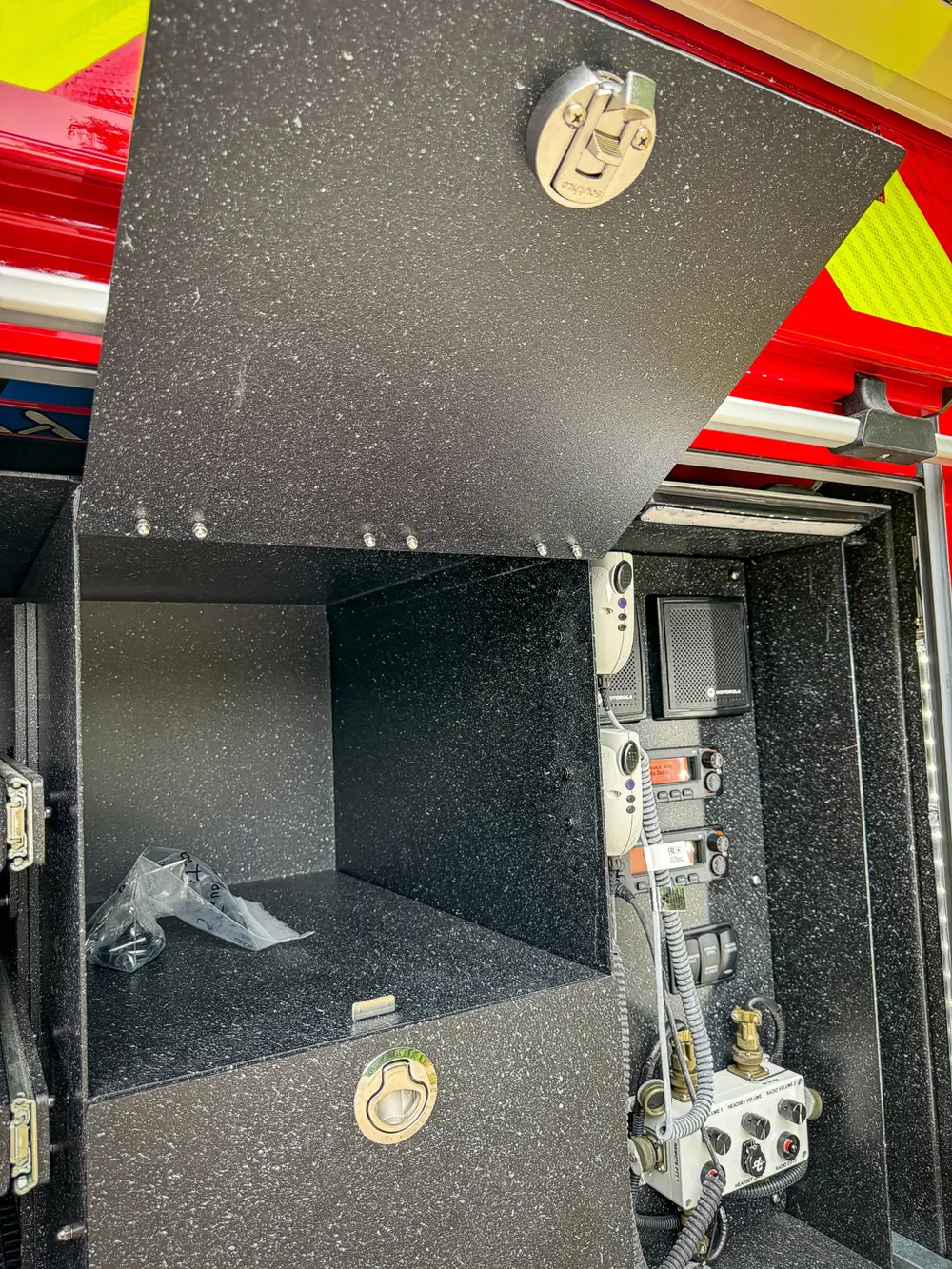 Rear compartment interior close-up with control module and shelf.