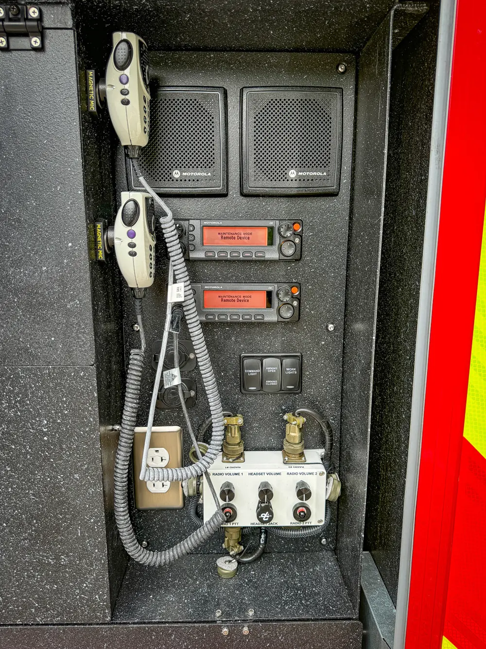 Rear side control panel close-up with radios, switches, and ports.