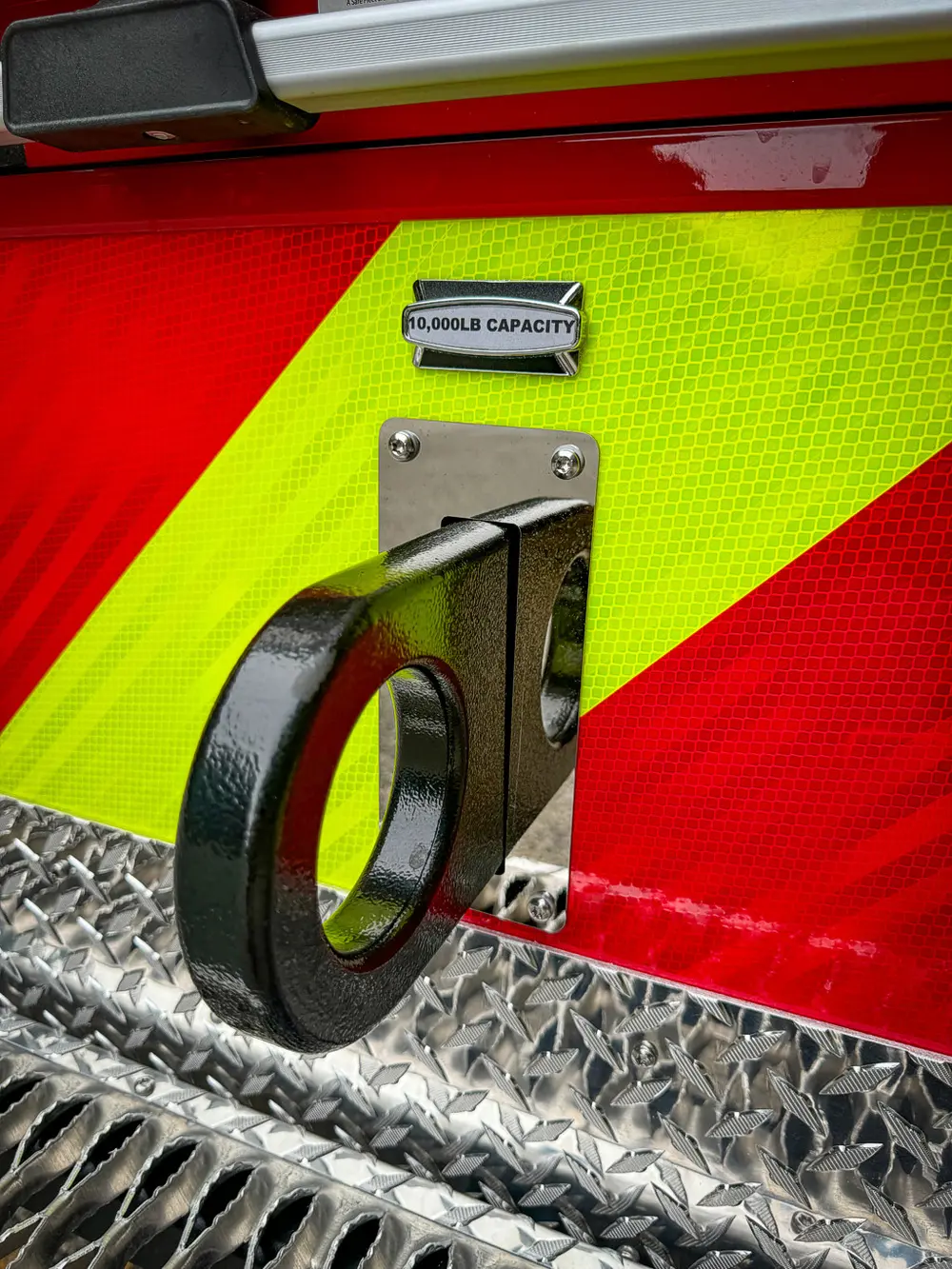 Rear side handle close-up mounted on chevron-striped panel.