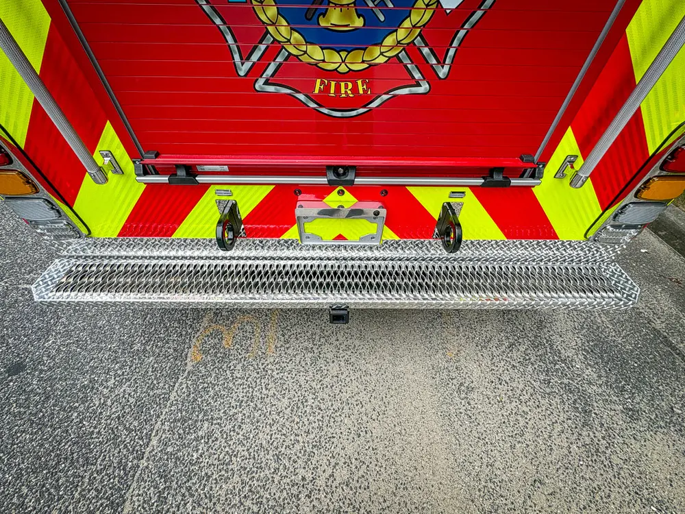 Lower rear chevron panel and bumper step close-up.