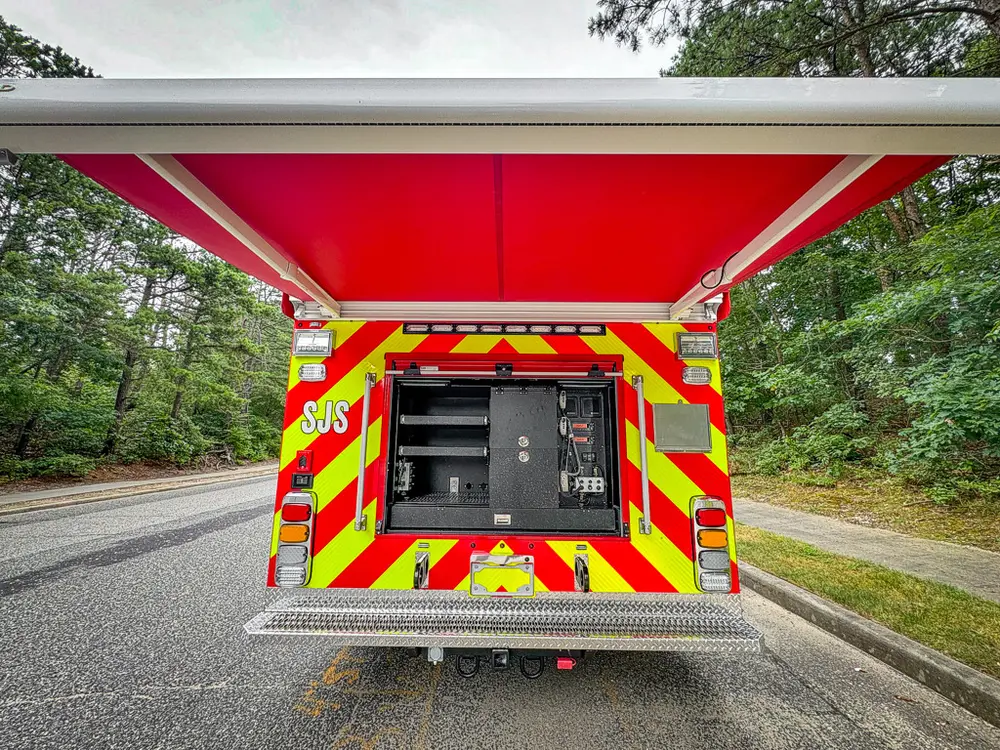 Straight rear view with center bay open and upper hatch raised.