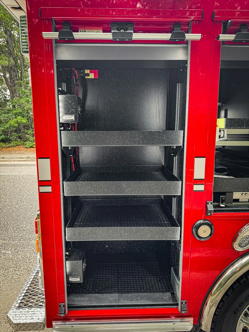 Vertical side compartment with shelf stack and empty storage levels.