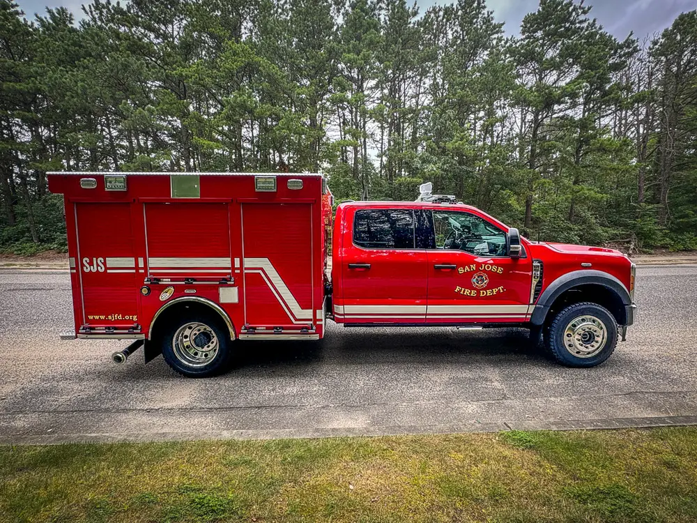Full right-side profile of truck with compartments closed.