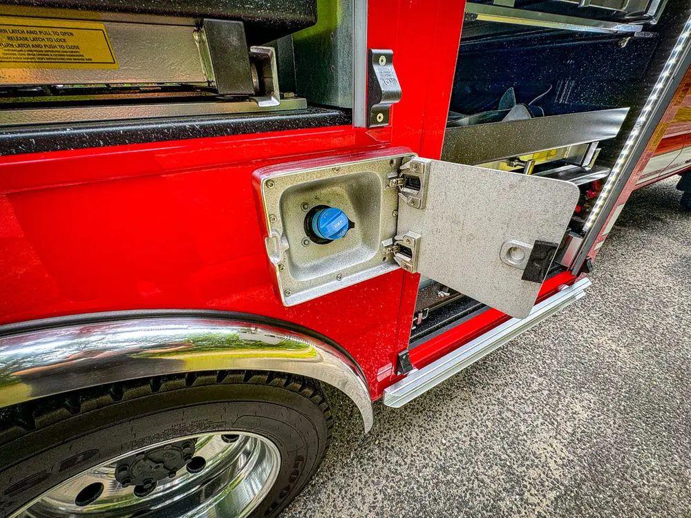 Lower side intake-port door open with blue fitting exposed.