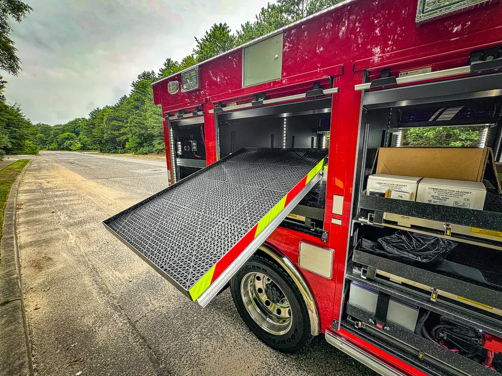 Open side bay with fold-out platform and interior shelves visible.