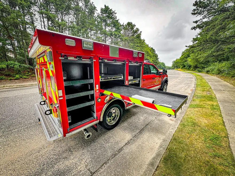 Right-rear angle with side platform extended and compartments open.