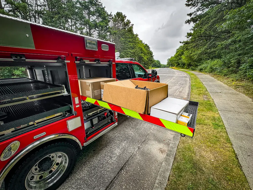 Side compartments open with large tray extended and box on shelf.