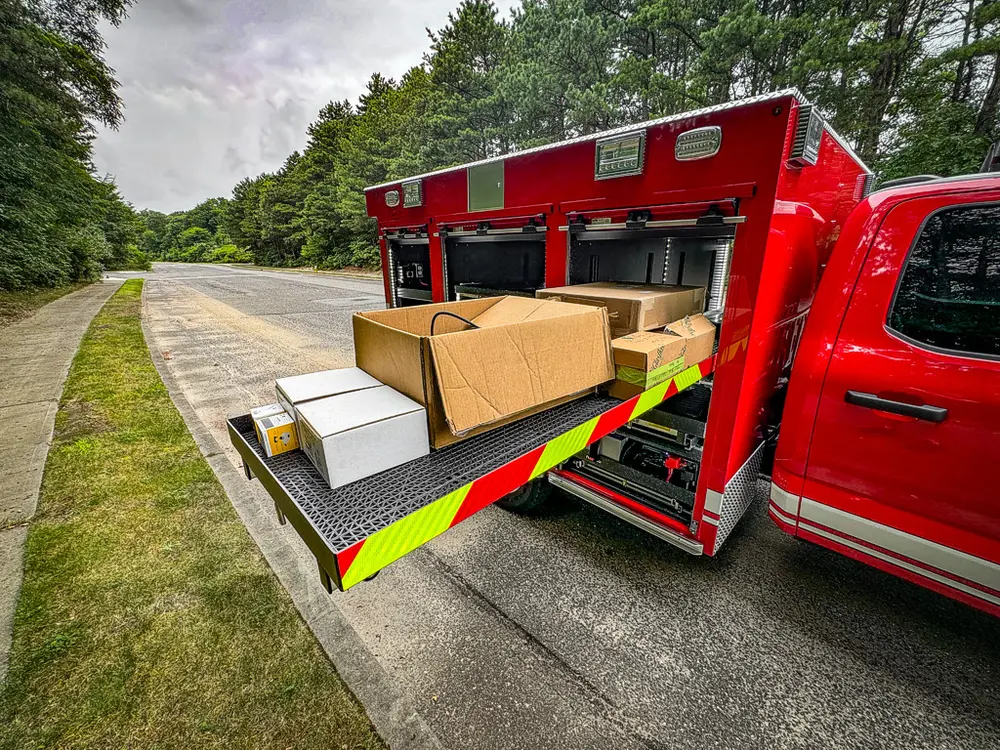 Long side slide-out tray fully extended with boxes on top.