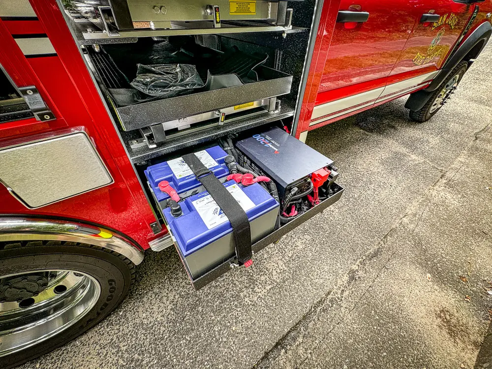 Close-up of side drawer system with batteries and mounted components.