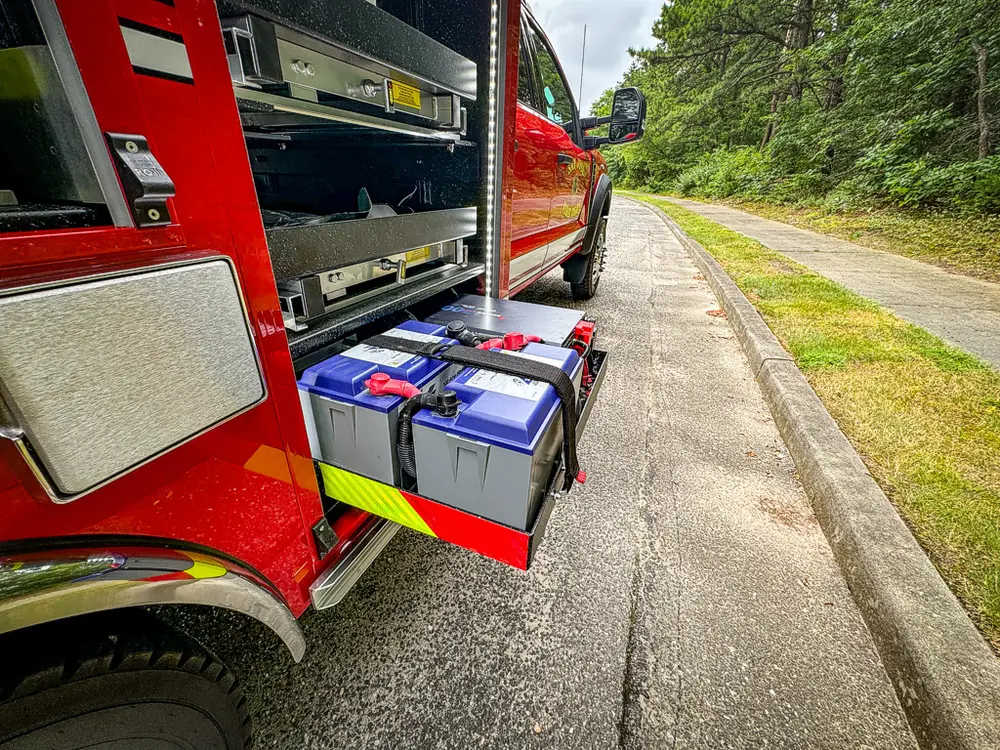 Right-side lower drawer extended with battery packs and wiring visible.