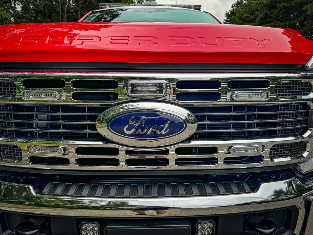Head-on grille close-up with chrome bars and Ford badge.