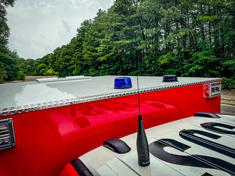 Top-side body and roofline view with blue warning lights.