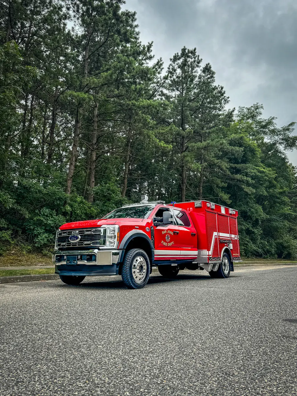 Front-left side view with right-side compartments open in background.