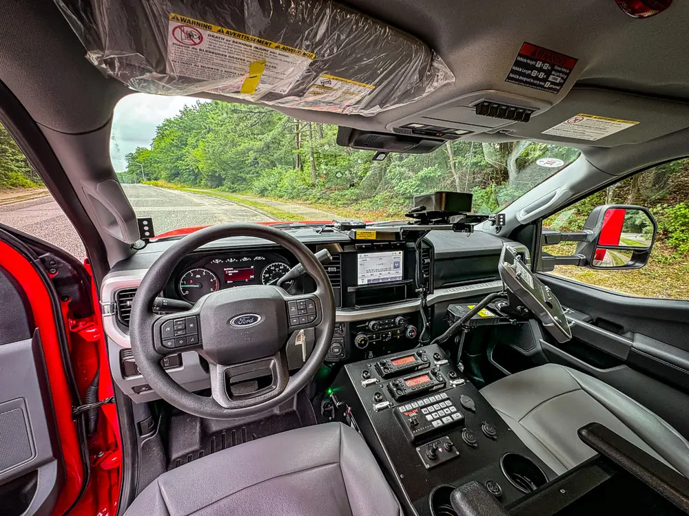 Wide cockpit view from driver side showing dashboard and center stack.