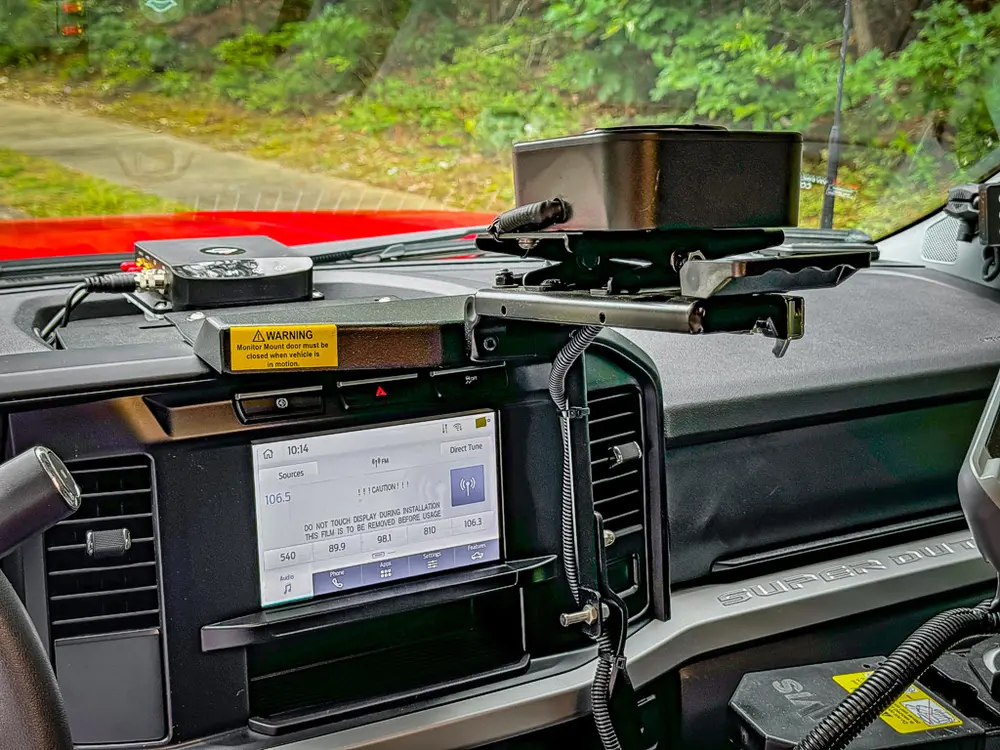 Center dash close-up with display screen and mounted tablet arm.