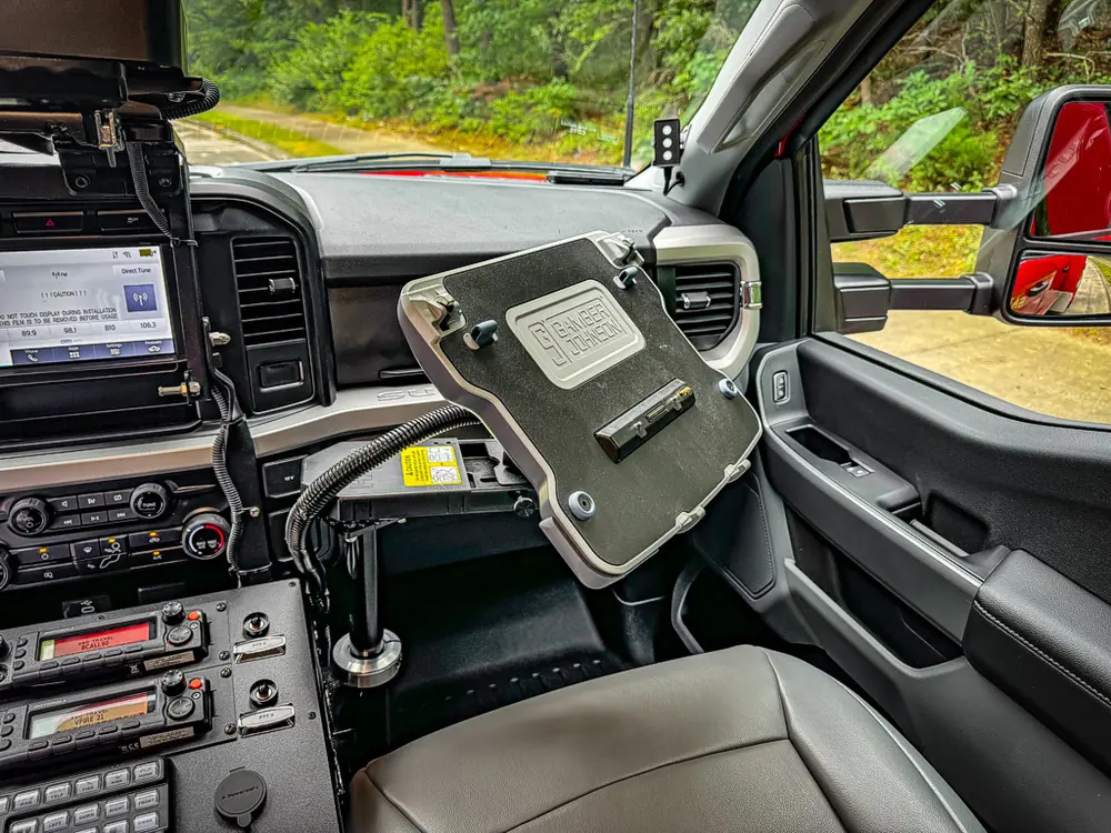 Passenger-side dashboard view with mounted tablet holder and controls.