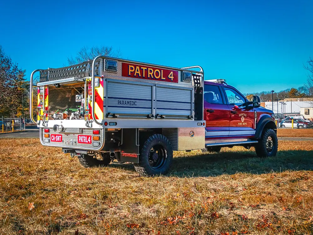 Rear-right angle with side rails and open rear equipment area.