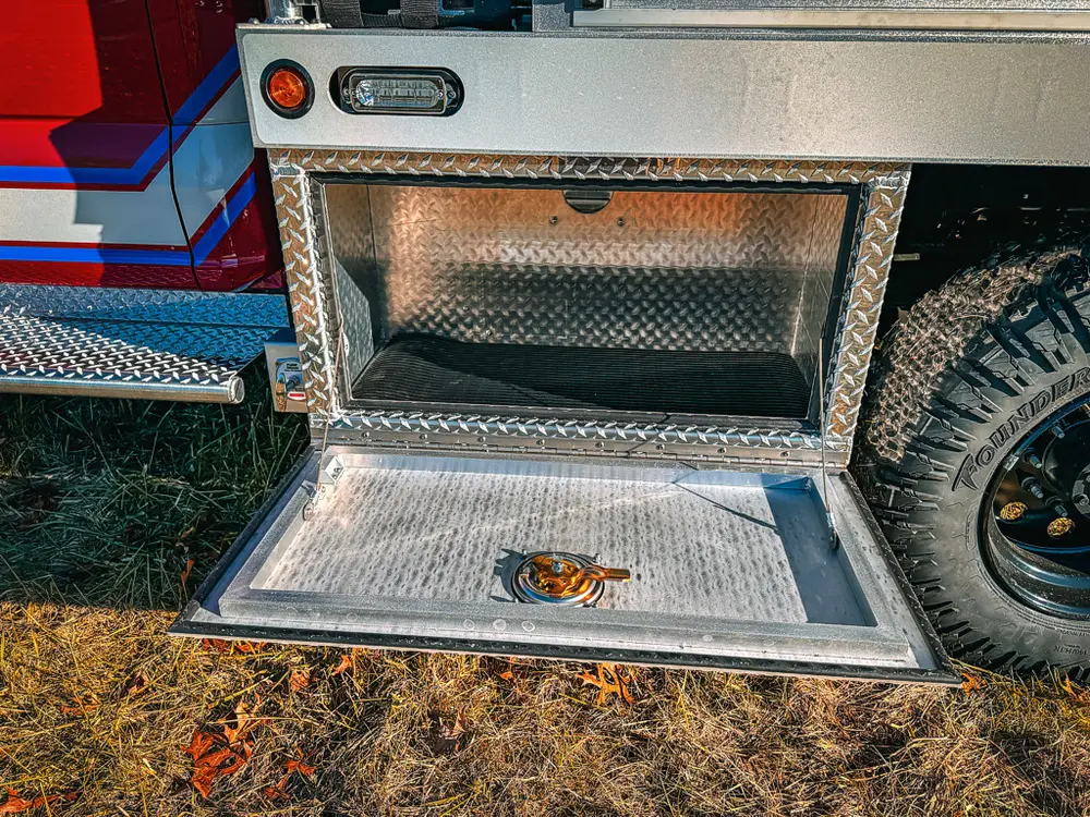 Lower side compartment open with intake fitting and empty floor.