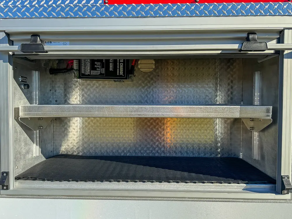 Open side compartment with upper shelf and clean interior.