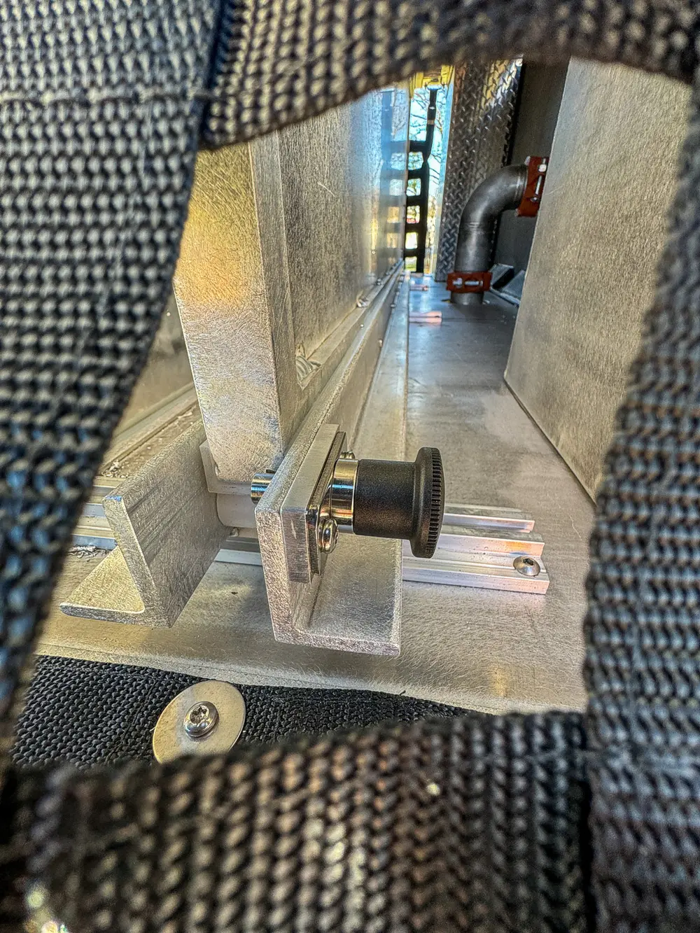 Upper side deck close-up with handle and metal divider wall.