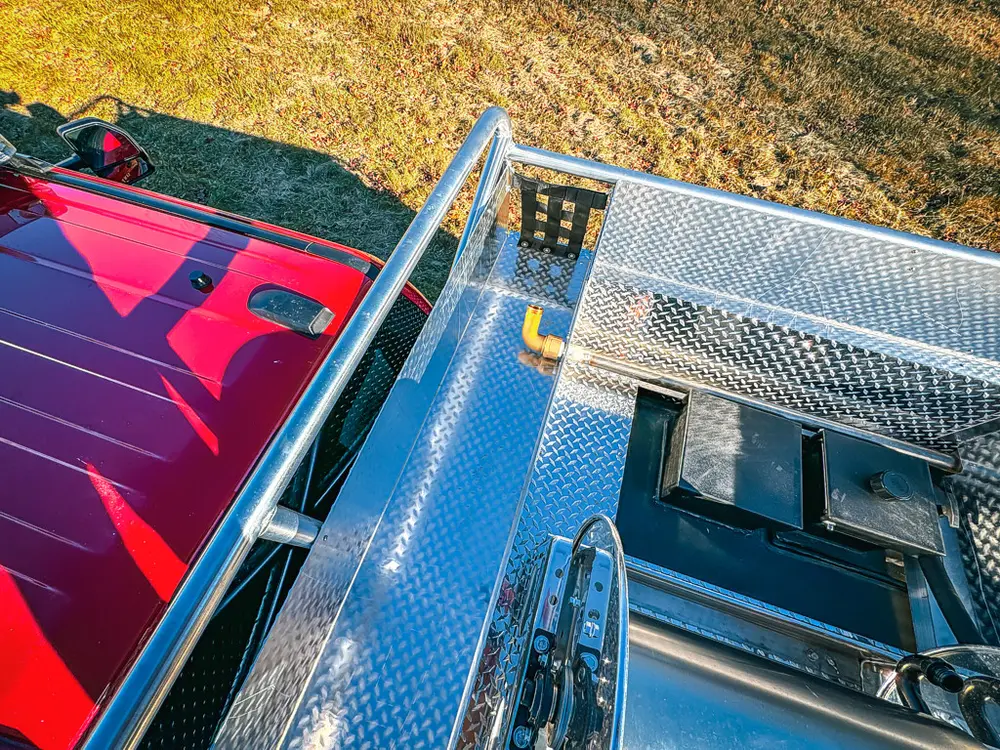 Top deck side close-up with open recessed hatch panel.