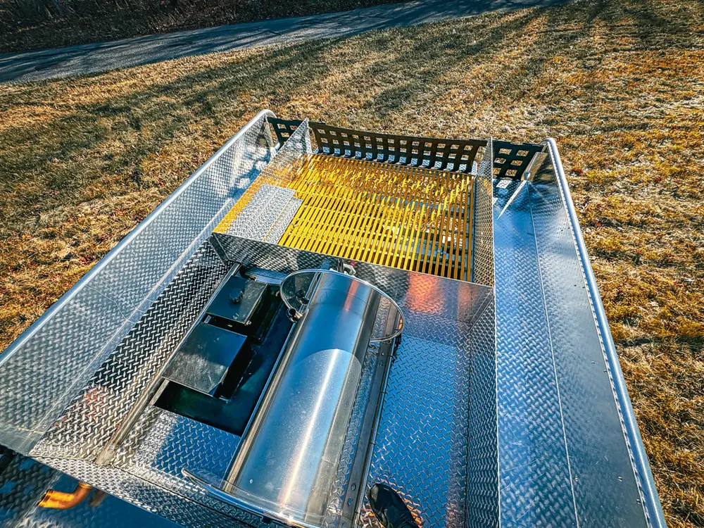 Top deck view with side rails and yellow grate channels.