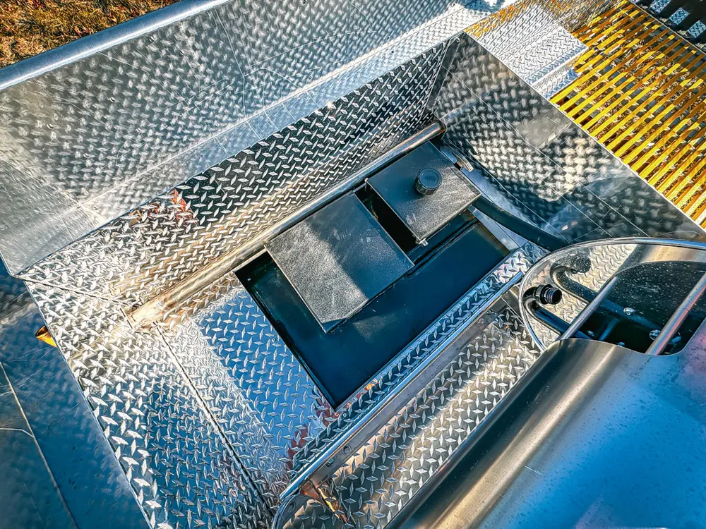 Upper deck hatch area close-up with open recessed compartment.