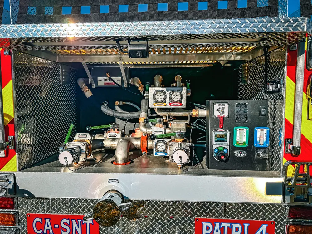 Rear pump area close-up with valves, gauges, and control hardware.