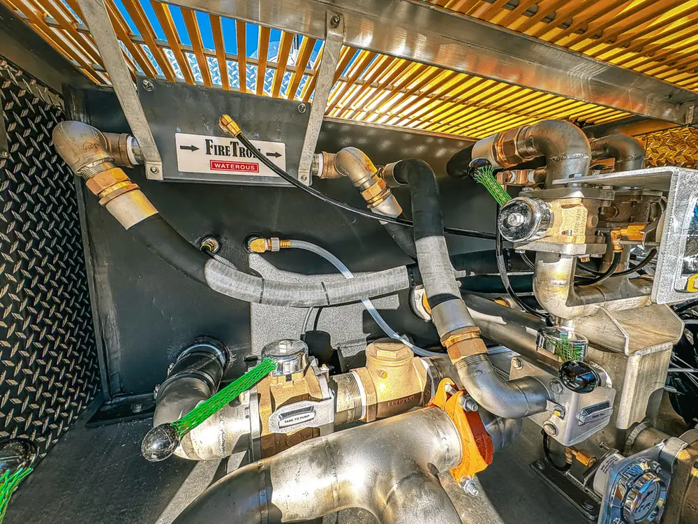 Pump bay interior close-up with fittings and control links.