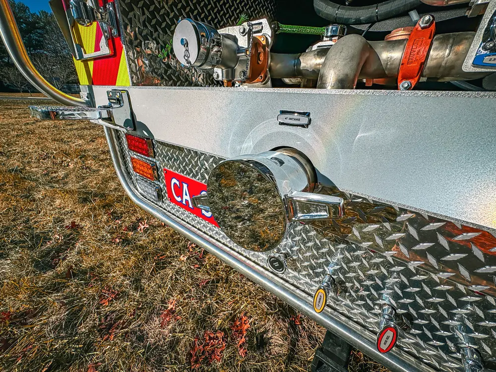 Rear corner close-up with capped discharge outlet and surrounding trim.